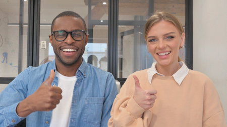 Portrait of Interracial Couple with Thumbs Upの写真素材