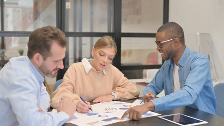 Multi Ethnic People Discussing Business Report at Workの写真素材