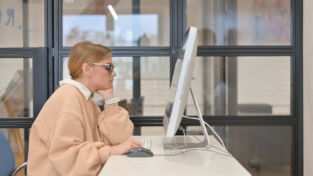 Tired Young Woman in Officeの写真素材