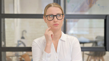 Portrait of Pensive Mature Business Woman Thinking New Ideaの写真素材