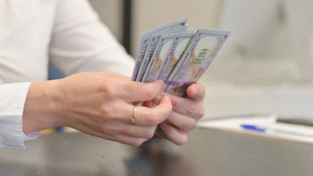 Close up of Hands Counting Money in Office