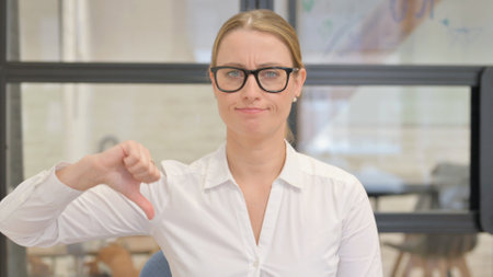 Portrait of Woman with Thumbs Downの写真素材