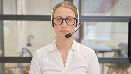 Mature Woman with Headset in Call Centerの写真素材