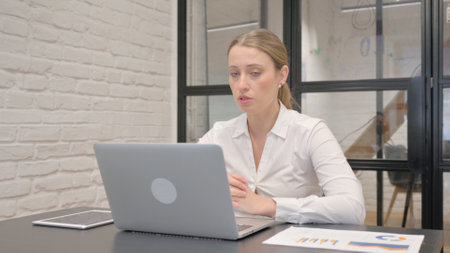 Middle Aged Business Woman Doing Video Chat with Clientsの写真素材