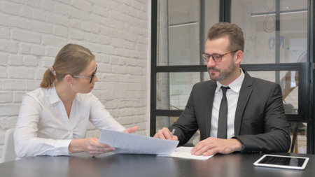 Close up of Mature Business Woman in Discussion with Employeeの写真素材