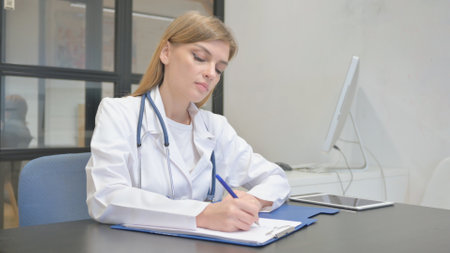 Female Doctor Writing a Document, Medical Reportの写真素材
