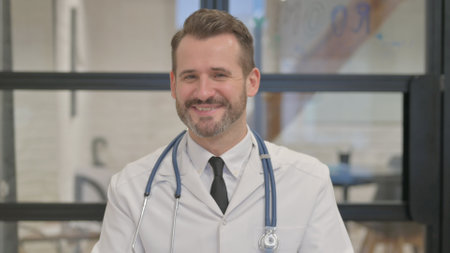 Portrait of Middle Aged Doctor Doing Video Chatの写真素材