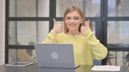 Thumbs Up with Both Hands by Casual Creative Woman in Officeの写真素材