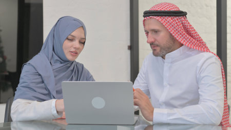 Muslim People Working on Laptop in Officeの写真素材
