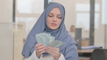 Portrait of Arab Woman Counting Moneyの写真素材