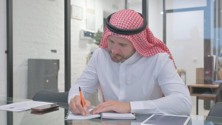 Middle Aged Man Writing in a Diaryの写真素材