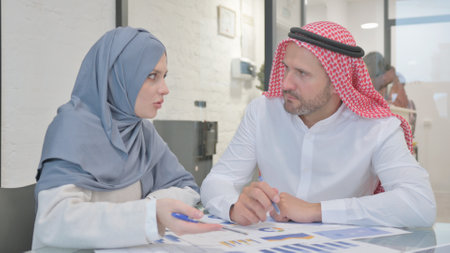 Muslim Colleagues Working on Documents in Officeの写真素材