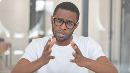 Webcam View of Casual African Man Doing Video Chat