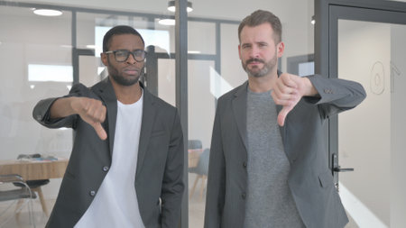 Portrait of Teammates in Office with Thumbs Downの写真素材