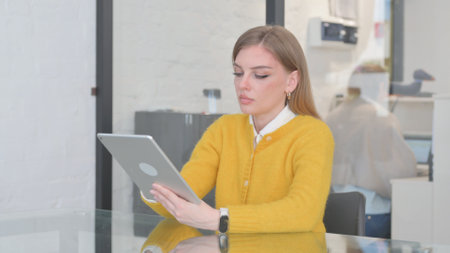 Blonde Casual Woman Using on Digital Tabletの写真素材