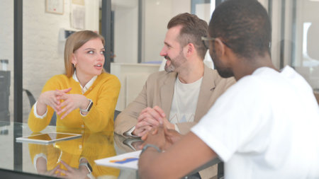Close up of Young Woman Talking with Teammatesの写真素材