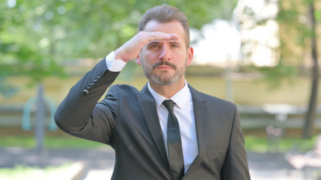 Searching Gesture by Young Businessman Outdoorの写真素材