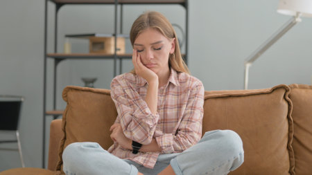 Young Woman Sitting on Sofaの写真素材