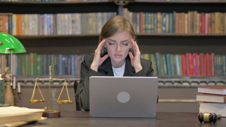 Female Lawyer having Headache with Laptopの写真素材