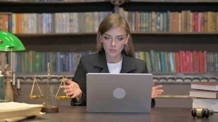 Female Lawyer Doing Video Chat on Laptopの写真素材