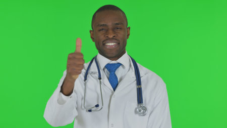 Portrait of African Doctor with Thumbs Up on Green Backgroundの写真素材