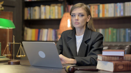 Female Lawyer Looking at Camera with Laptopの写真素材