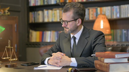 Middle Aged Lawyer Trying to Write a Letter in Officeの写真素材