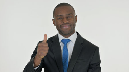 Portrait of African Businessman with Thumbs Up on White Backgroundの写真素材