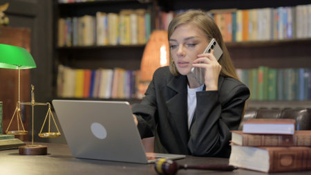 Female Lawyer Talking on phone with Laptopの写真素材