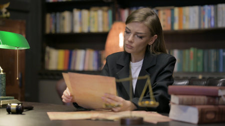 Female Lawyer Reading Court Orders in Officeの写真素材