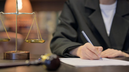 Close up of Female Judge Writing Verdict in Officeの写真素材