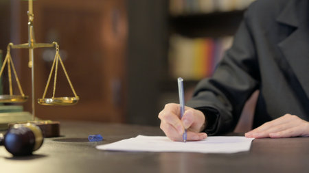 Close up of Female Judge Writing Verdict in Officeの写真素材