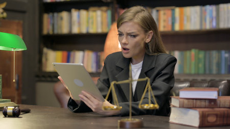 Female Lawyer with Loss on Tablet in Officeの写真素材