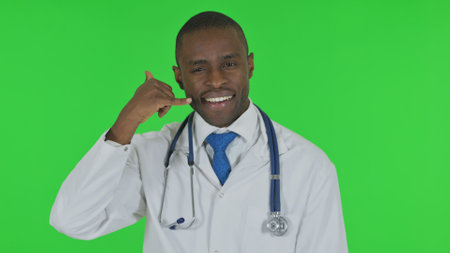 Portrait of Doctor inviting People for Help, Call Me on Green Backgroundの写真素材