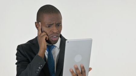 Portrait of African Businessman with Loss on Tablet on White Backgroundの写真素材