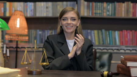 Portrait of Excited Female Lawyer Clapping while in Officeの写真素材