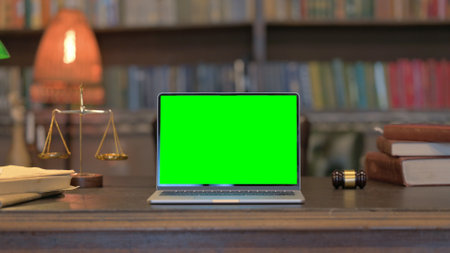 Laptop with Green Screen on Desk of Courtroom