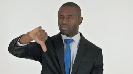 Portrait of African Businessman with Thumbs Down on White Backgroundの写真素材
