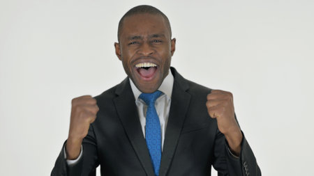 Portrait of African Businessman Celebrating Success on White Backgroundの写真素材