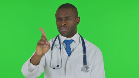 Portrait of African Doctor in Denial on Green Backgroundの写真素材