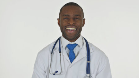 Portrait of Smiling African Doctor on White Backgroundの写真素材