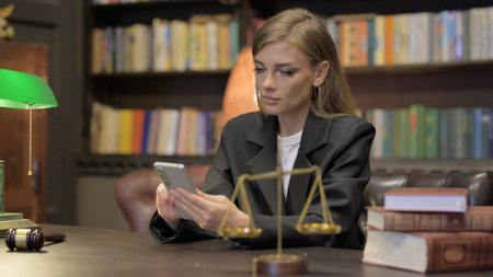 Female Lawyer Using Smartphone in Officeの写真素材