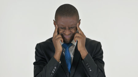 Portrait of African Businessman with Migraine on White Backgroundの写真素材