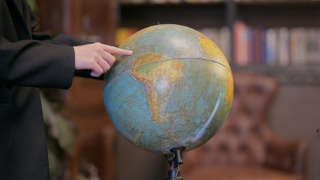 Close up of Male Hand with Globe of Worldの写真素材