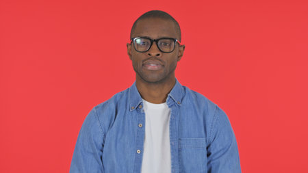 Serious Casual African Man on Red Background, Portraitの写真素材