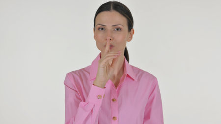 Portrait of Business Woman with Finger on Lips on White Backgroundの写真素材