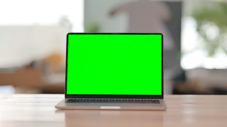 Laptop with Green Screen on Deskの写真素材