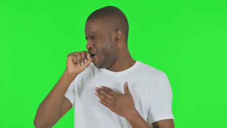 Portrait of Coughing African Man on Green Backgroundの写真素材