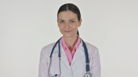 Portrait of Female Doctor Shaking Head in Acceptance on White Backgroundの写真素材