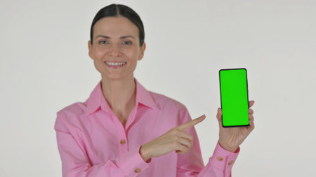 Portrait of Business Woman Showing Smartphone with Green Screen on white Backgroundの写真素材